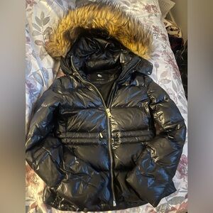 Zara shiny Stylish black Down jacket. Features a faux fur hood. Size is XS